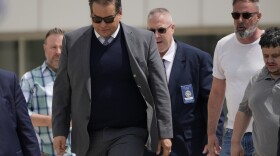 Former U.S. Rep. George Santos, left, leaves federal court after being sentenced to more than seven years in prison for fraud and identity theft, Friday, April 25, 2025, in Central Islip, N.Y.