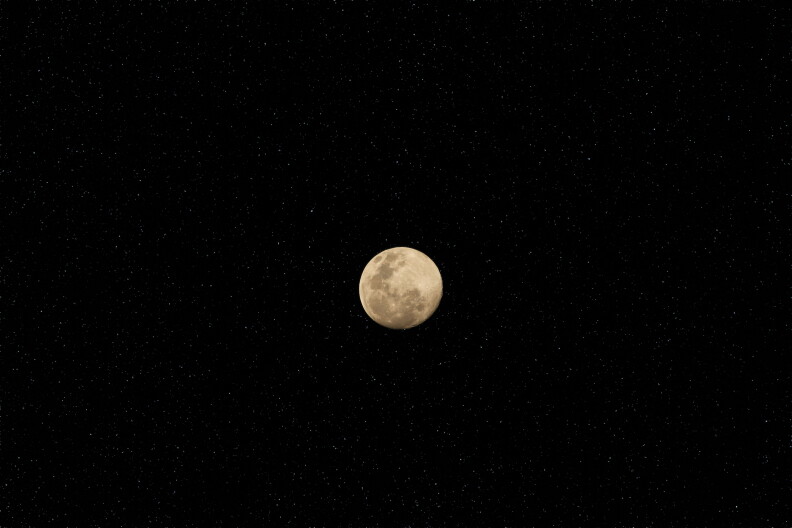 A supermoon sits in a dark night sky.