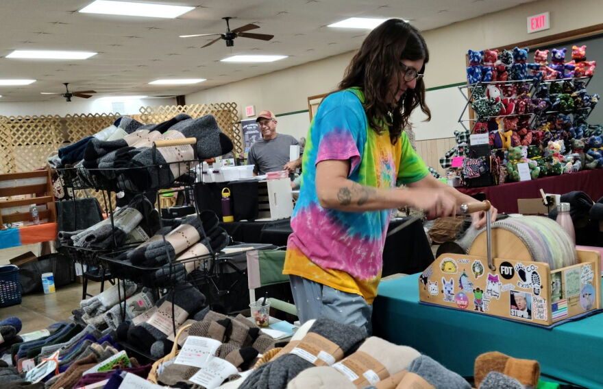 Lindsey Moore processing fiber with a drum carder during Saturday’s Fiber Fest at the 4-H Center in Macomb.
