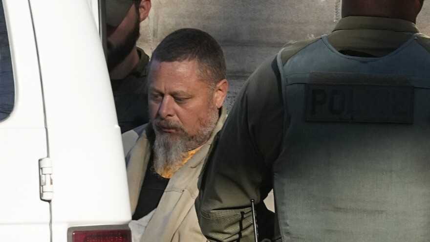Officers escort Richard Matthew Allen out of the Carroll County courthouse following a hearing, Nov. 22, 2022, in Delphi, Ind. Allen confessed multiple times to the murders of two teenage girls — Abigail Williams, 13, and Liberty German, 14 — he is charged with killing in a phone call to his wife while in prison, according to court documents released Wednesday, June 28, 2023.
