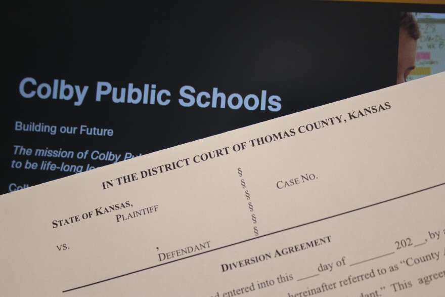 A blank diversion agreement sits in front of a computer with the Colby Public School's website. 