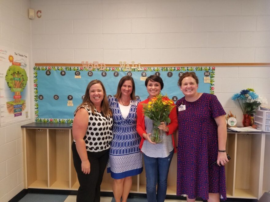 Oakcrest Elementary staffers celebrate after presenting Elizabeth Peebles (Center, Holding Flowers) the Teacher Of The Year award. Peebles particularly enjoys teaching Florida history. (Anthony Nicotera/WUFT News)