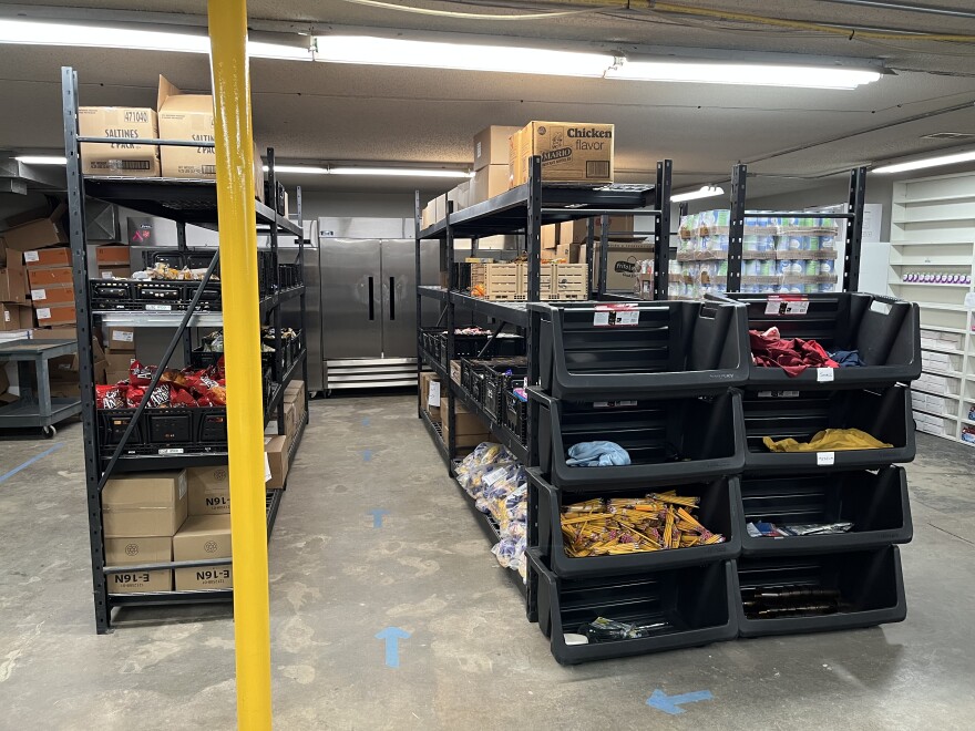 A store room of food and supplies is stacked on shelving units at the Gillette Service Center's new larger facility.