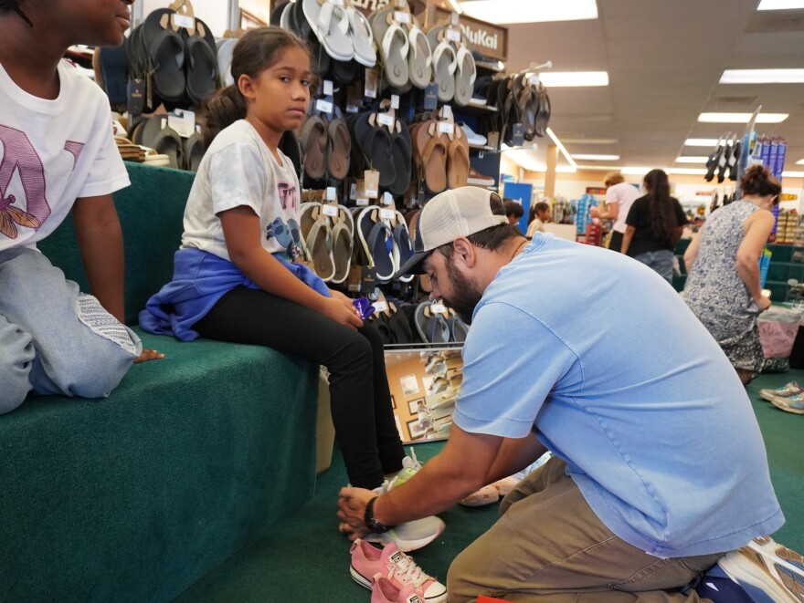 Immokalee children get new shoes through the Laces of Love program. Staff members at Snyderman's Shoes in Naples recently fitted the kids with footwear.