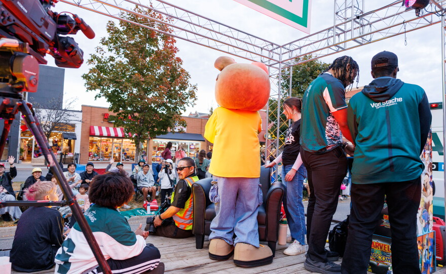 Lansing State Journal photojournalist Matthew Dae Smith briefly joins the WKAR and College of Communication Arts and Sciences float in the Michigan State University Homecoming Parade in East Lansing, Mich., on Oct. 9, 2026.