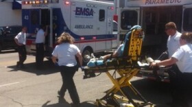 A student is rushed to a waiting ambulance.