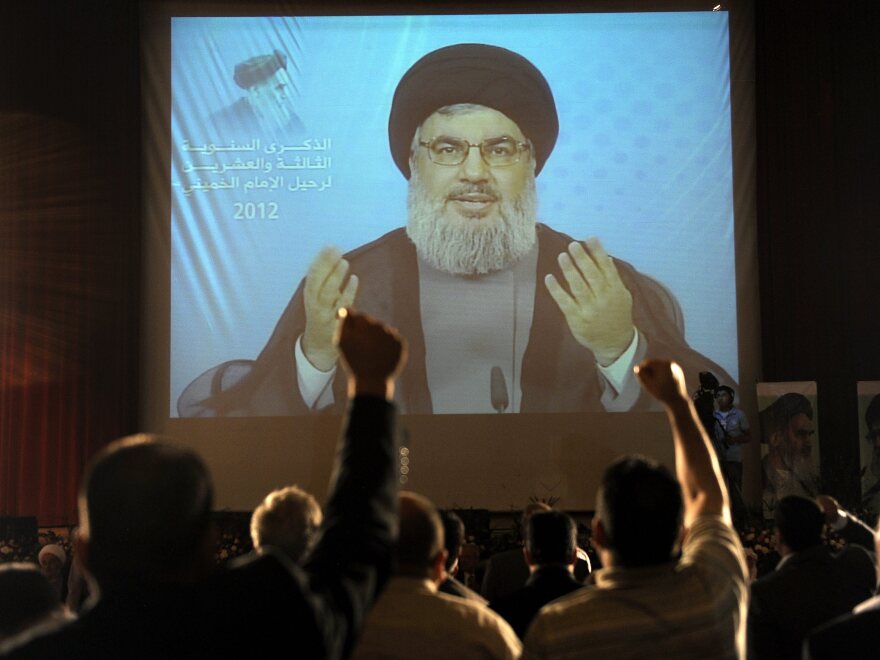 Hezbollah leader Sayyed Hassan Nasrallah, seen here delivering a speech via video in Beirut in June, has dismissed Assir's calls for disarmament.