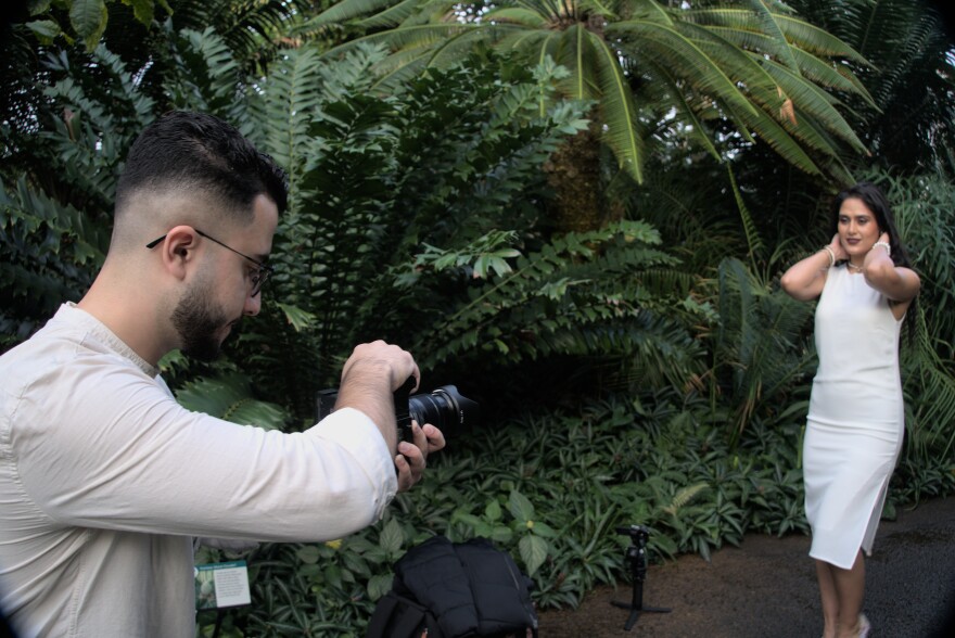 Pouya Zabihullah takes photos of a client in the Climatron at the Missouri Botanical Garden. He learned different photography techniques and how to light subjects from YouTube tutorials.