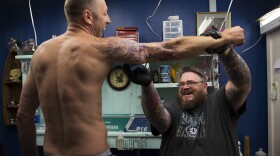 Mike Heath, left, laughs  as Blue Collar Tattoo owner Sean Ewan cleans his arm before tattooing a tribute to Metallica, on Wednesday, July 5, 2017, in Bremerton, Washington. 