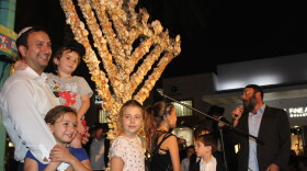 Members of the Miami Beach Jewish community celebrate Hanukkah by lighting the eighth candle on the Lincoln Road seashell menorah on Sunday, Dec. 9, 2018.