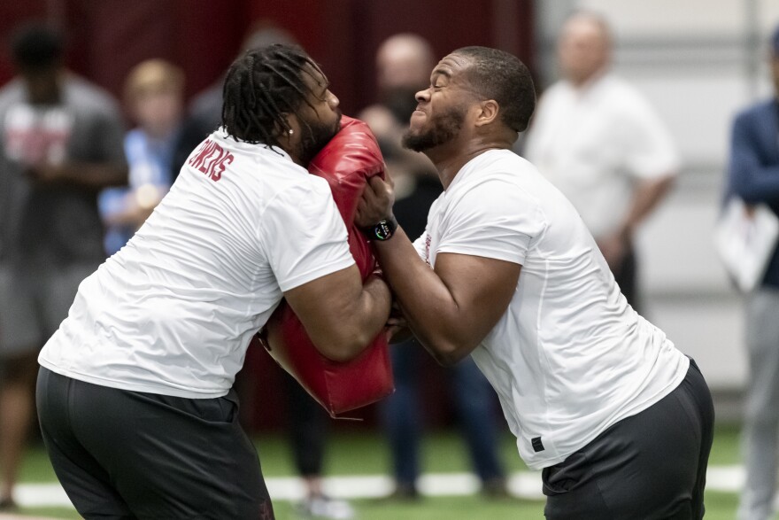 Former Alabama football players Chris Owens and Evan Neal participate in positions drills at Alabama's NFL Pro Day, Wednesday, March 30, 2022, in Tuscaloosa, Ala. (AP Photo/Vasha Hunt)