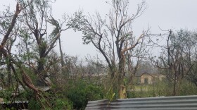 Debris covers the ground in Saipan on Wednesday, April 15, 2026, as a super typhoon with ferocious winds and relentless rains, shredded tin roofs and forced residents to take cover from flying tree limbs.
