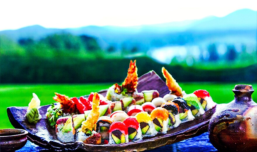 Colorful sushi, artfully displayed on a traditional serving dish