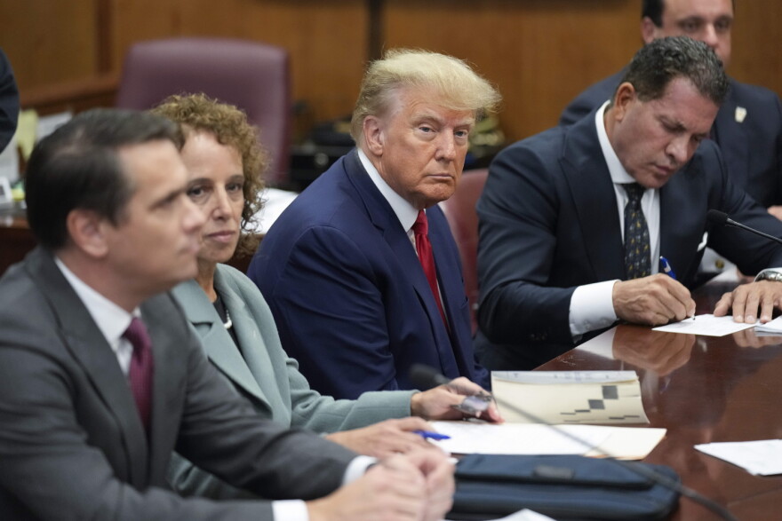 Former President Donald Trump sits at the defense table with his legal team in a Manhattan court, Tuesday, April 4, 2023, in New York. Trump is appearing in court on charges related to falsifying business records in a hush money investigation, the first president ever to be charged with a crime.