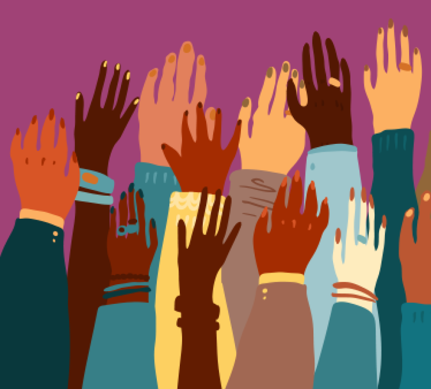 A multicultural group of raised hands.