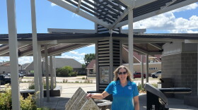 Erin Reed, executive director of the Dickinson County Trails Board, stands at a trailhead in Spirit Lake, Iowa, in June 2026. (Bret Hayworth, Siouxland Public Media News)