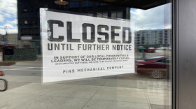 A "closed" sign is posted on a closed duckpin bowling alley and bar in downtown Columbus.