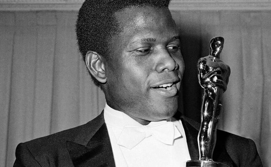 Sidney Poitier holding an Oscar