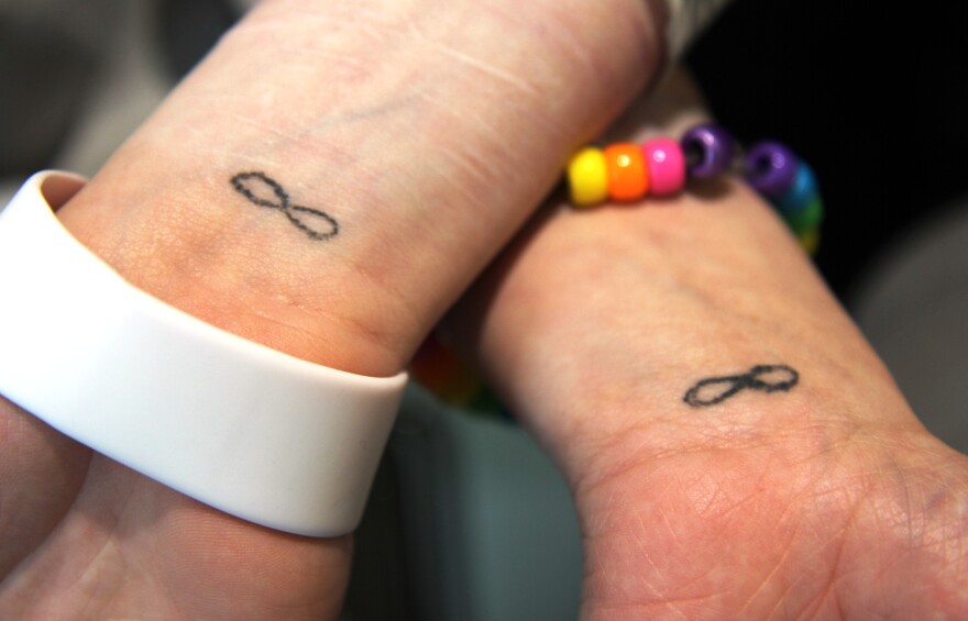 The two young women show their matching tattoos. Hillman/KSKA