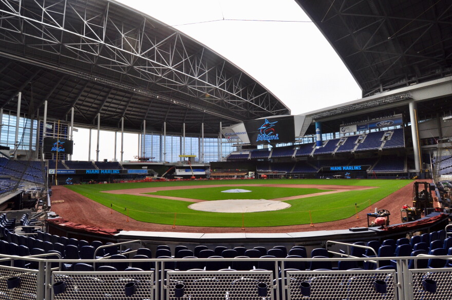 Workers prepare Marlins Park for the Marlins' 2019 opening day. The team hopes to rebuild trust with local fans in the effort to boost business.