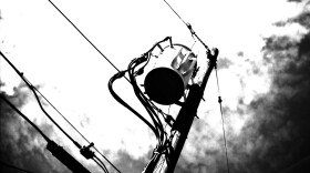 A black-and-white film photo of a power line.