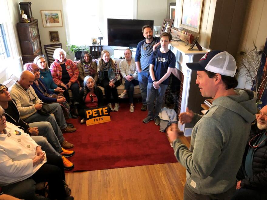 Clarke Tucker (right) speaks to supporters of former South Bend, Ind. Mayor Pete Buttigieg at a home in Little Rock.