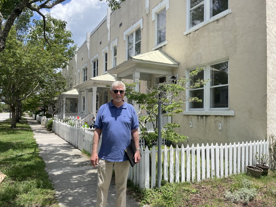 Glenn Harbeck stands in front of the first townhomes to ever be built in Wilmington. They were constructed between 1912 and 1917.