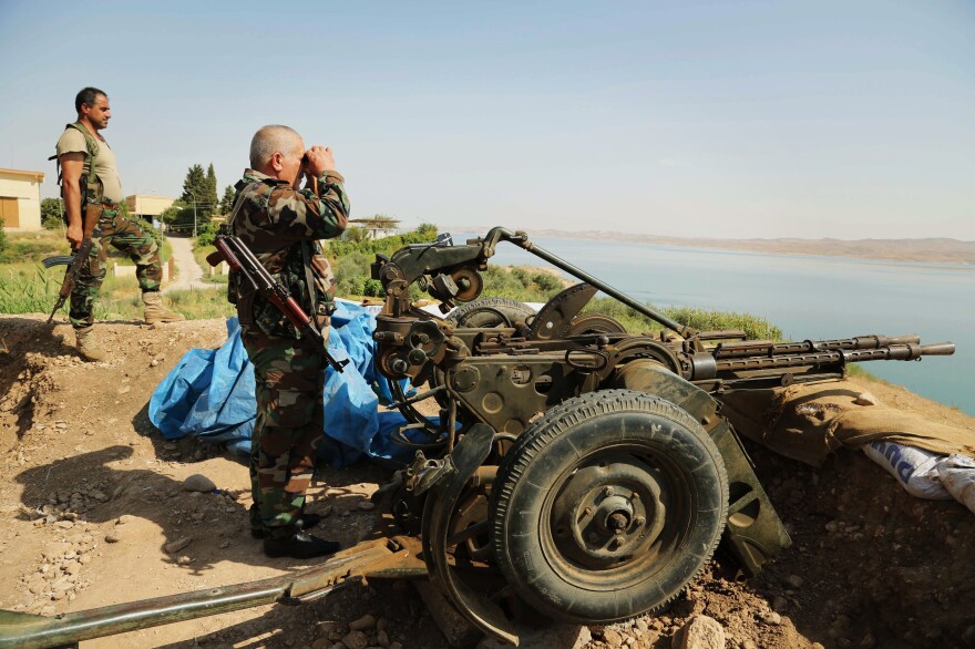 Kurdish forces, known as peshmerga, stand guard near the Mosul Dam on Aug. 17. U.S. airstrikes against the Islamic State allowed the peshmerga to move in and take the area around the dam recently.