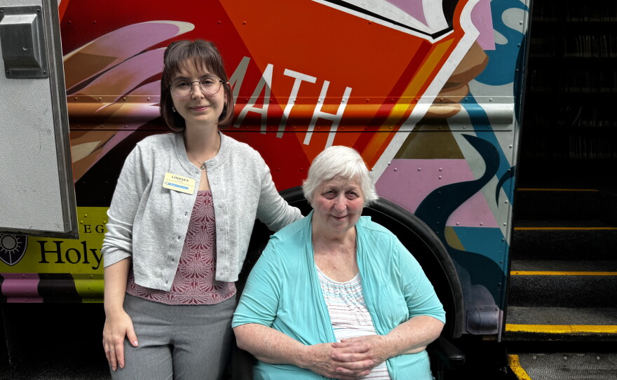 Mary Iram, right, with Lindsey Zanni at the Saint Francis Rehabilitation and Nursing Center in Worcester during a visit of the Worcester Public Library’s bookmobile.