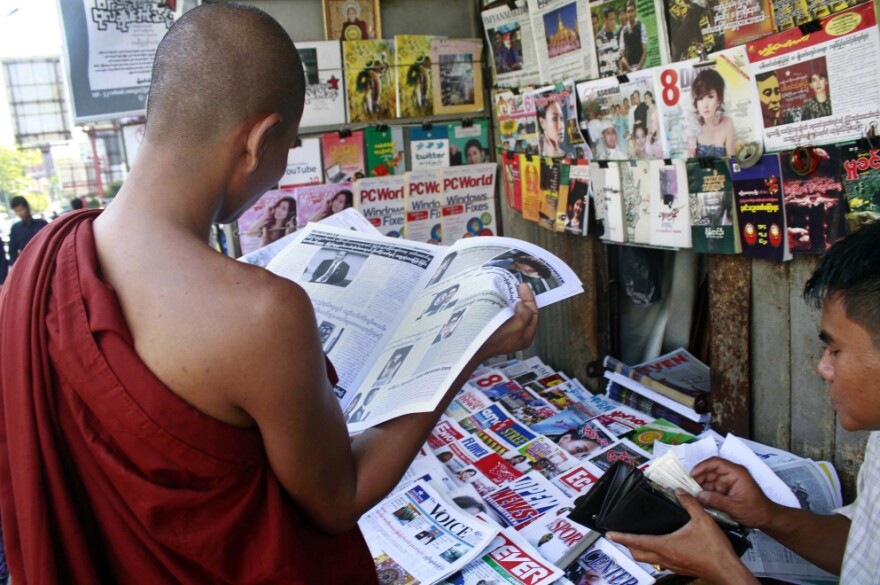 A Buddhist monk reads a newspaper in Yangon on Tuesday. Newspaper articles that would have been rejected by Myanmar's draconian state censors just months ago are making it into print, in one of many signs that the long-repressed country is becoming more open.