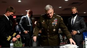 Chairman of the Joint Chiefs of Staff Gen. Mark A. Milley (C) departs a Senate Armed Services Committee hearing on the conclusion of military operations in Afghanistan and plans for future counterterrorism operations at the Dirksen Senate Office building on Capitol Hill in Washington, DC.