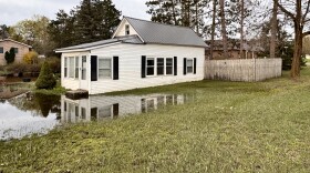 A white house sits in a water-soaked yard after flood waters in Cadillac, Michigan receded. 