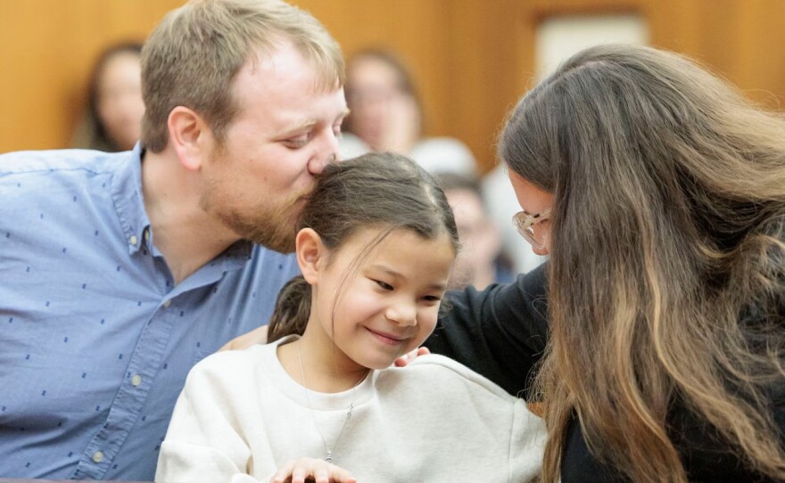 Sam Collinsworth and Stephanie Tribo with their daughter, Airi Tribo, 7, during Adoption Day before Washtenaw County Circuit Court Judge Arianne Slay at the Washtenaw County Circuit Court in Ann Arbor on Tuesday, Nov. 25, 2025.