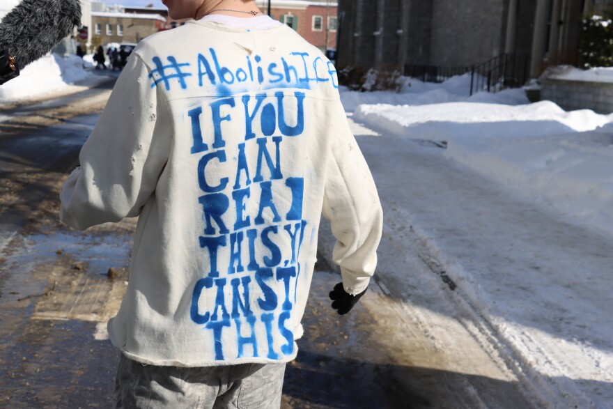 A Concord High student wears a shirt that says, "If you can read this, you can stop this," during a walkout organized by students in protest of