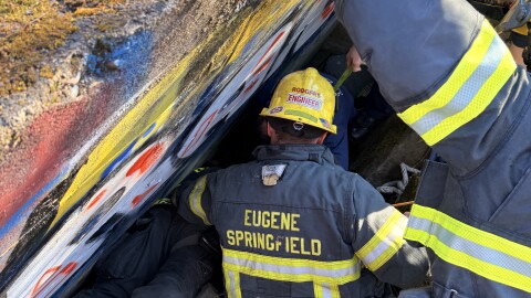 ESF said in a press release that it took about 20 people to extract a trapped man from between a concrete wall and quarry stone near the Willamette River Sunday in Eugene.