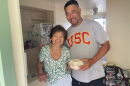 Damian Loo stands with a Kauaʻi resident after delivering a hot meal to her after Hurricane Lowell hit earlier this month.