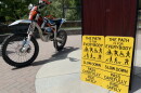 New signs on the Greenbelt will remind users to slow down and share the pathway. Some e-bikes, like the off-roading dirt bike pictured above, require permits and are not allowed on the Greenbelt.