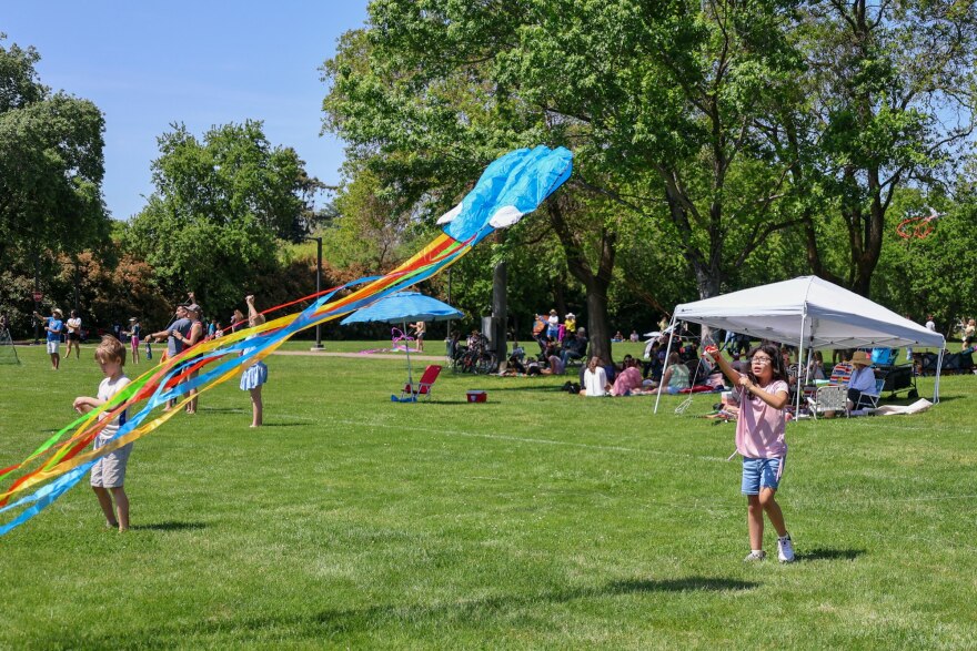 Child flying a kite at Kite Day 2024