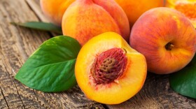 fresh peaches on wood background