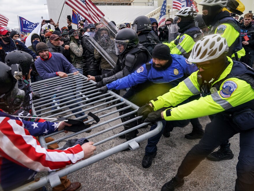 In this Jan. 6, 2021, file photo rioters try to break through a police barrier at the Capitol in Washington. Congress is set to hear from former security officials about what went wrong at the U.S. Capitol on Jan. 6. AP Photo/John Minchillo, File