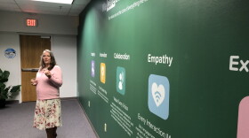 Veronica Soultz, U.S. Contact Center Director for RelateCare, shows a mural displaying the company's key values at their facility in Sherwood Thursday.