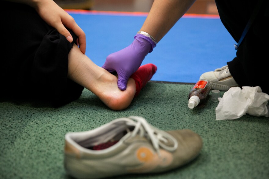 Zhang often makes Chinese herbal medications for her students' sprained ankles.