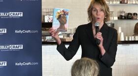  GOP gubernatorial hopeful Kelly Craft holds up a copy of "All Boys Aren't Blue" at a campaign event at the Gaslight Diner in Jeffersontown in April 2023. Craft says the memoir by George M. Johnson about growing up Black and queer is an example of a "woke" agenda pushed on children.