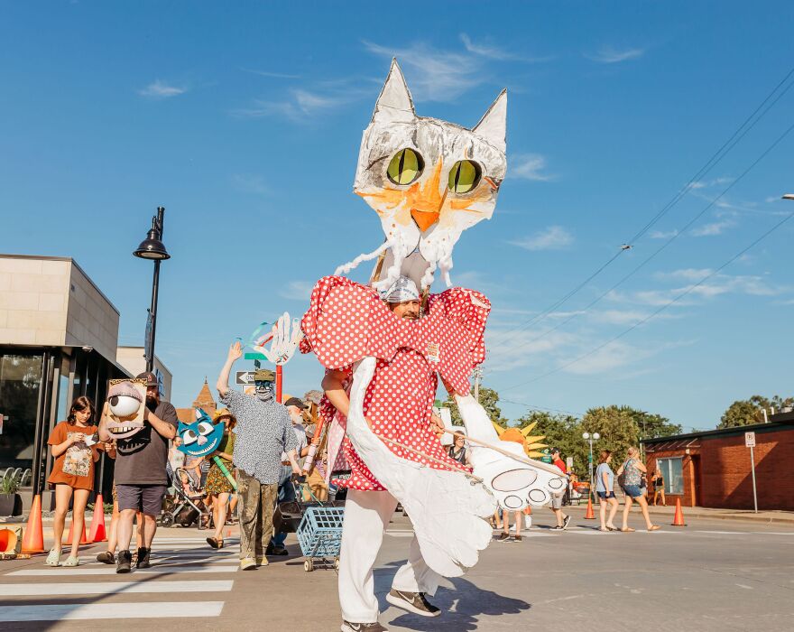 Bollman operates a cat puppet from inside during a "puppet stroll."