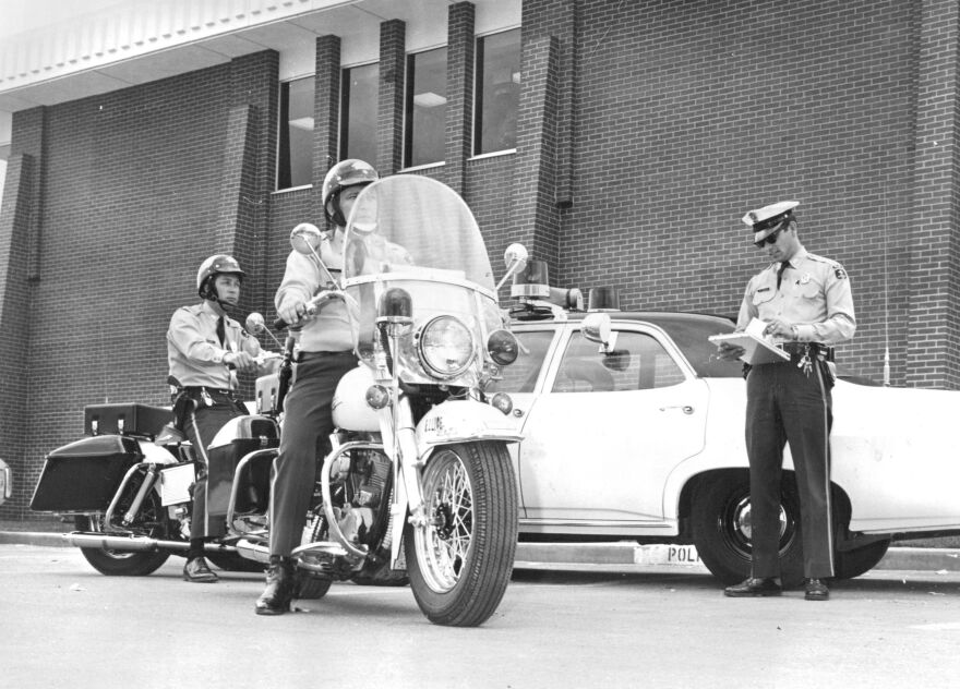 A Special Overland Park traffic enforcement unit, consisting of two motorcycles ridden by Ronald L. Grove (left), and James R. Siener, Patrolmen, and a marked police car, driven by Ray J. Vallejo, was put into operation recently by the city in a stepped-up traffic enforcement program. members of the special unit are to patrol the city, investigate serious traffic accidents, train other department members and enforce traffic regulations.