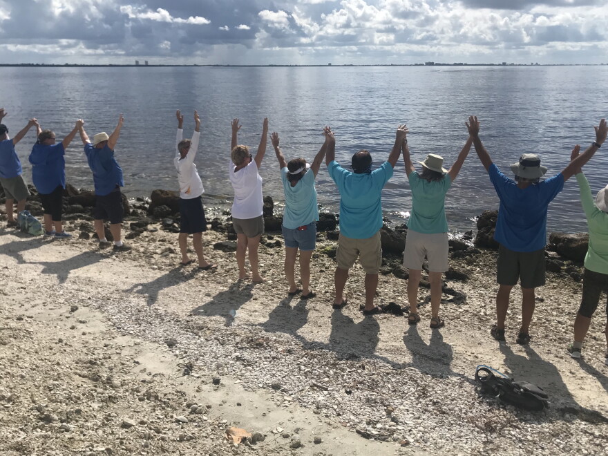Demonstrators along Sanibel Causeway join "Hands Along the Water."