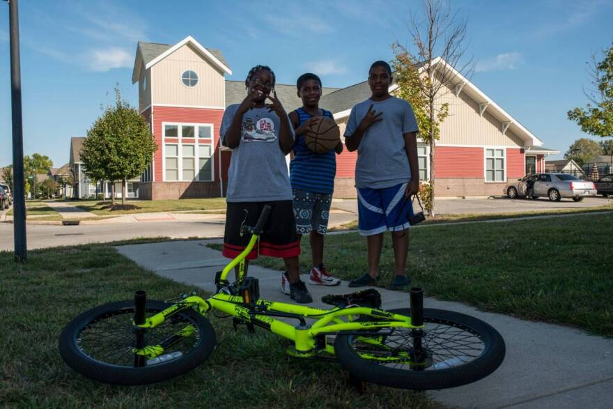 Mario (R) and his friends take a break from playing to pose for photographer Aaron Pierce.