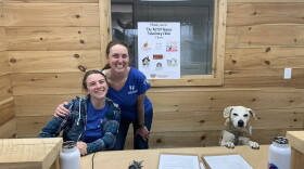 Veterinary Technician Alexa Graham and Dr. Leslie Interlandi at the front desk of the NEPA Rescue Veterinary Clinic with Baby.