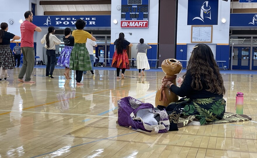 Kumu Iwalani Raes, coordinator of the Asian and Pacific Islander Student Program at Lane Community College, leads students and volunteers through a Hula dance, which the group will present during a break in the powwow's scheduled events.