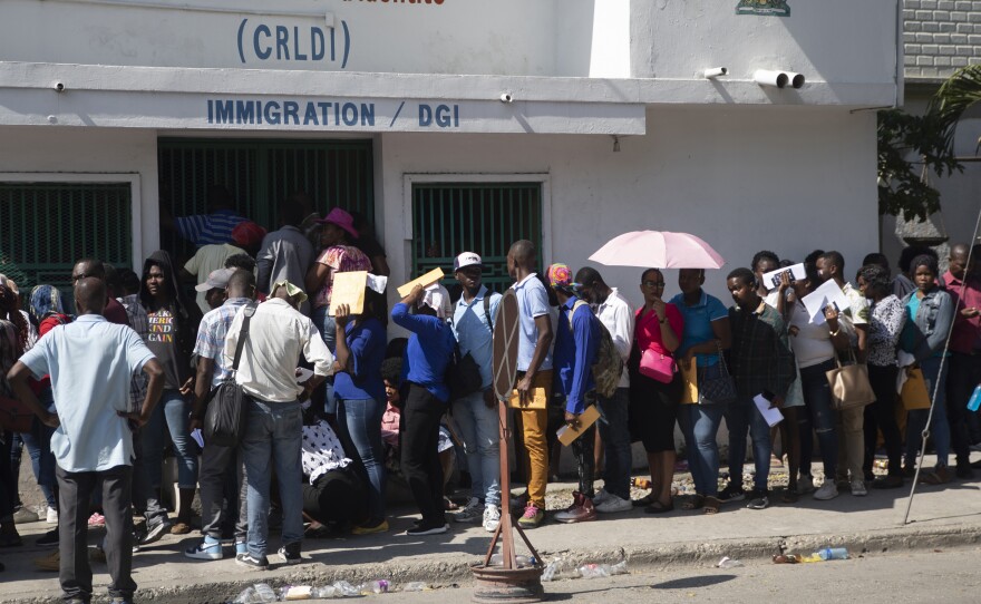 A group of people line up in front of a building